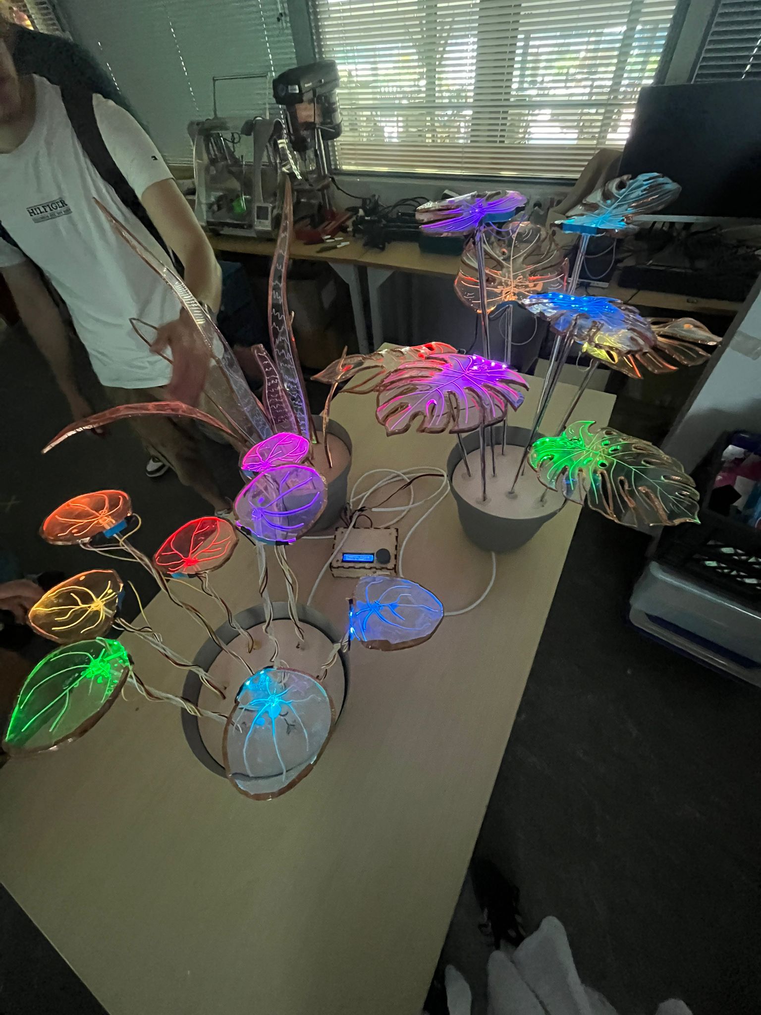 Close-up of PlantBand leaves showing the copper touch-trace patterns and embedded LEDs